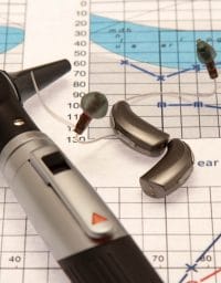 Otoscope and Hearing Aids Close up on a Audiogram